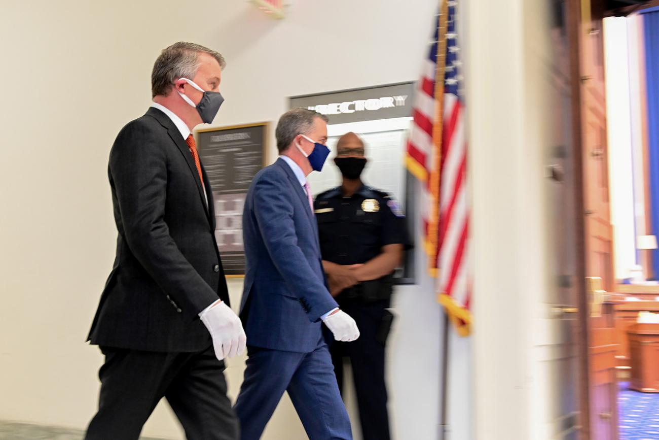 The photo shows the former official walking somewhere in the House building. 