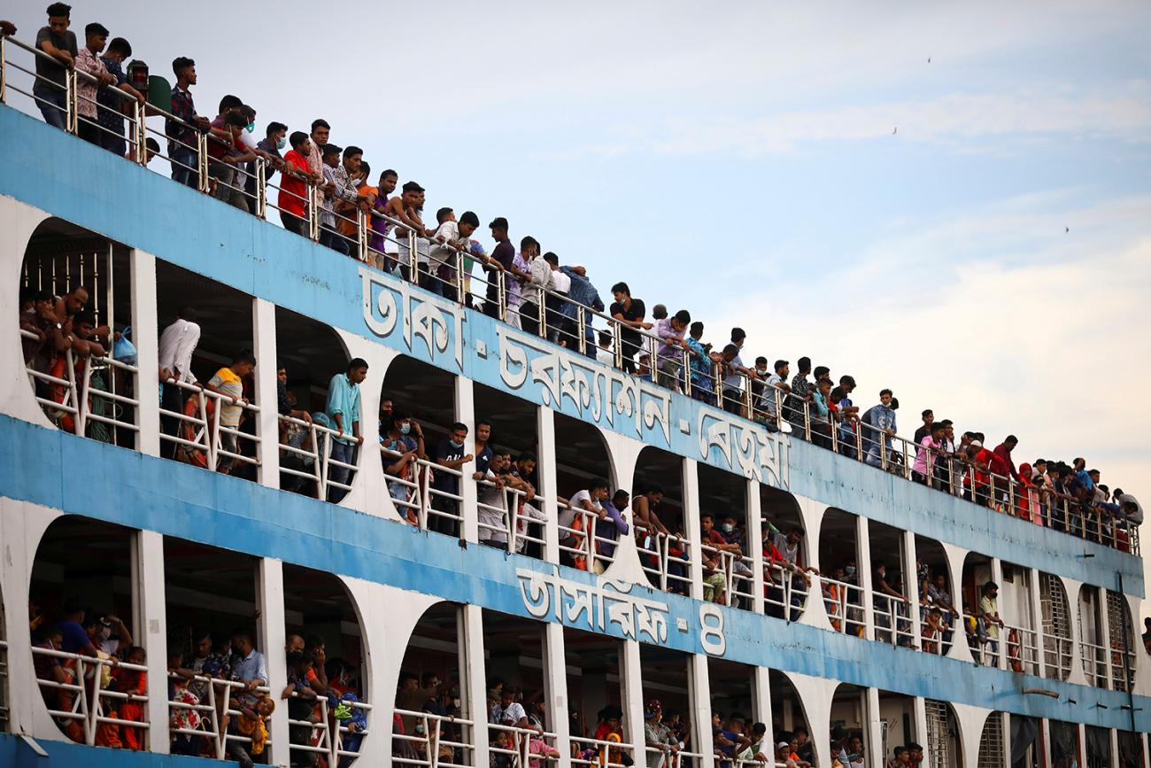 The photo shows the ferry from the side with all balconies jammed with people, most not wearing masks. 