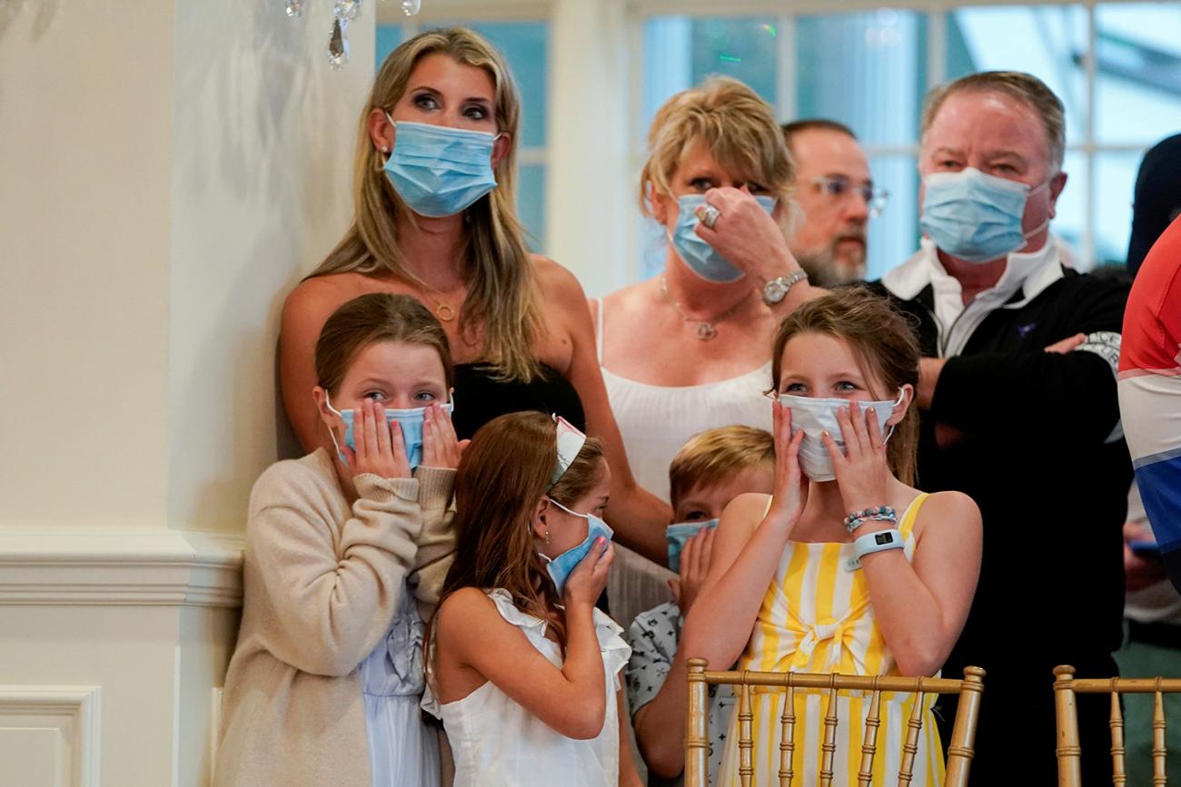 The photo shows a family and perhaps other people standing together in a fancy resort setting. 