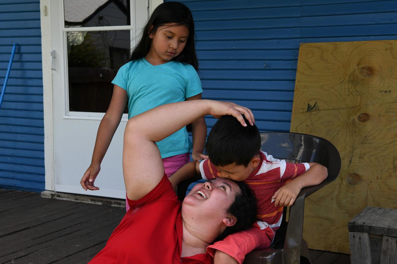 The photo shows Irma laughing with her kids. 