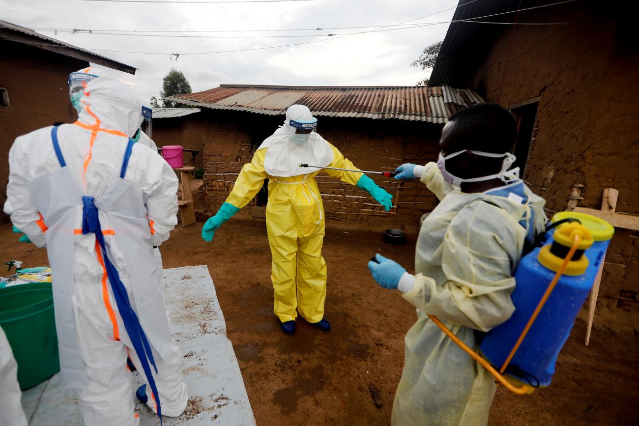 Kavota Mugisha Robert, a health-care worker, who volunteered in the Ebola response, decontaminates his colleague after he entered the house of 85-year-old woman, suspected of dying of Ebola, in the eastern Congolese town of Beni in the Democratic Republic of Congo, October 8, 2019.