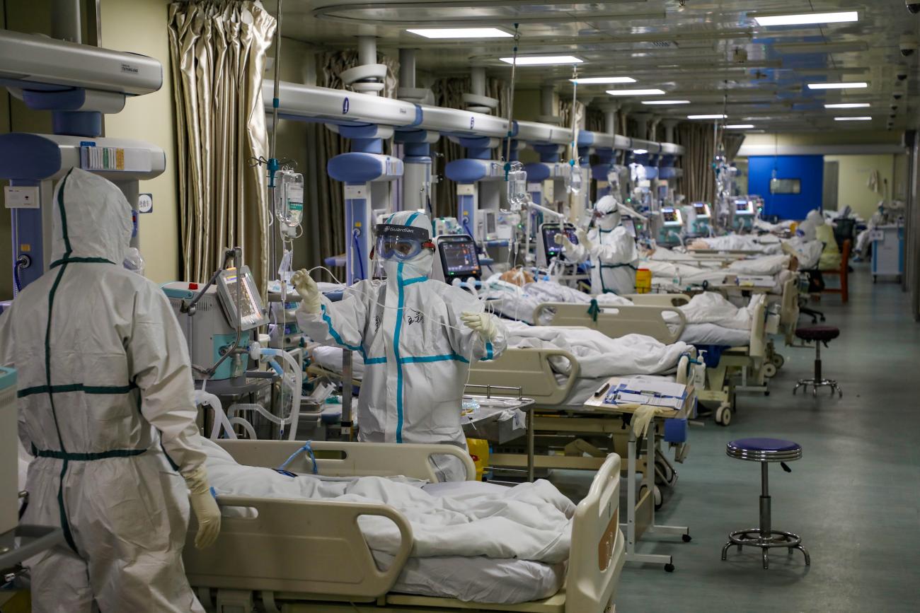 Medical workers in protective suits attend to novel coronavirus patients at the intensive care unit (ICU) of a designated hospital in Wuhan, Hubei province, China, February 6, 2020.