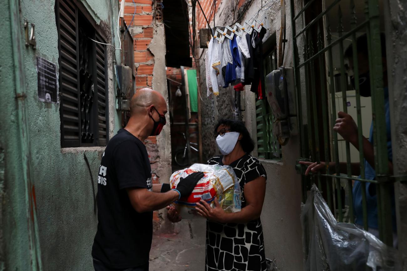 A man receives food-aid distributed by a Brazilian non-governmental organization, for poor families amid the coronavirus disease outbreak at Heliopolis slum in Sao Paulo, Brazil, June 18, 2020. 