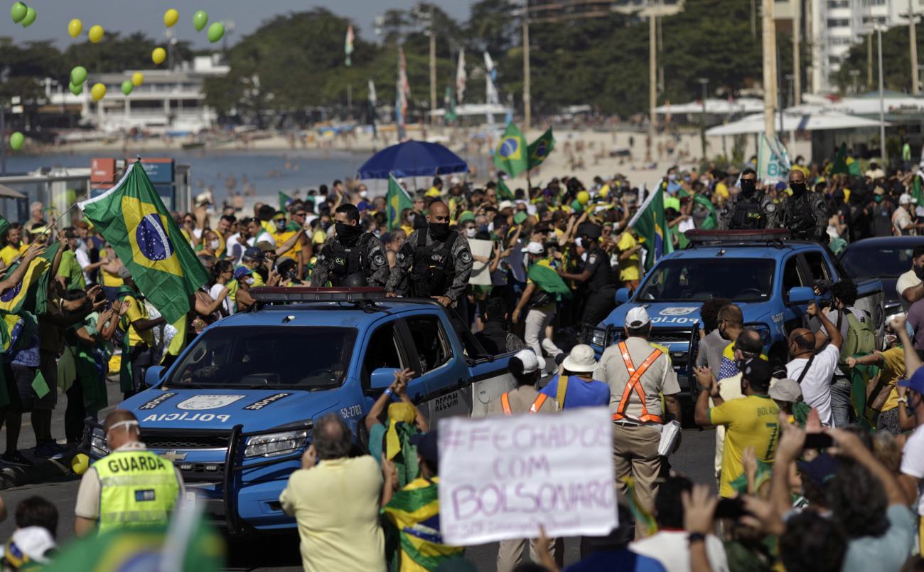 Policemen patrol as people attend a demonstration in support of Brazil's President Jair Bolsonaro on Copacabana beach in Rio de Janeiro, Brazil on June 21, 2020.