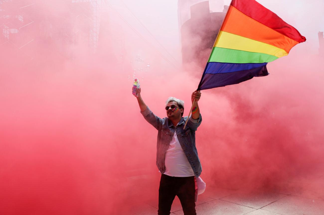 A participant flutters a rainbow flag at the Angel of Independence monument although the Mexican LGBT community called for an online gay pride celebration as a protective measure amid the coronavirus disease outbreak, in Mexico City, Mexico on June 27, 2020. 