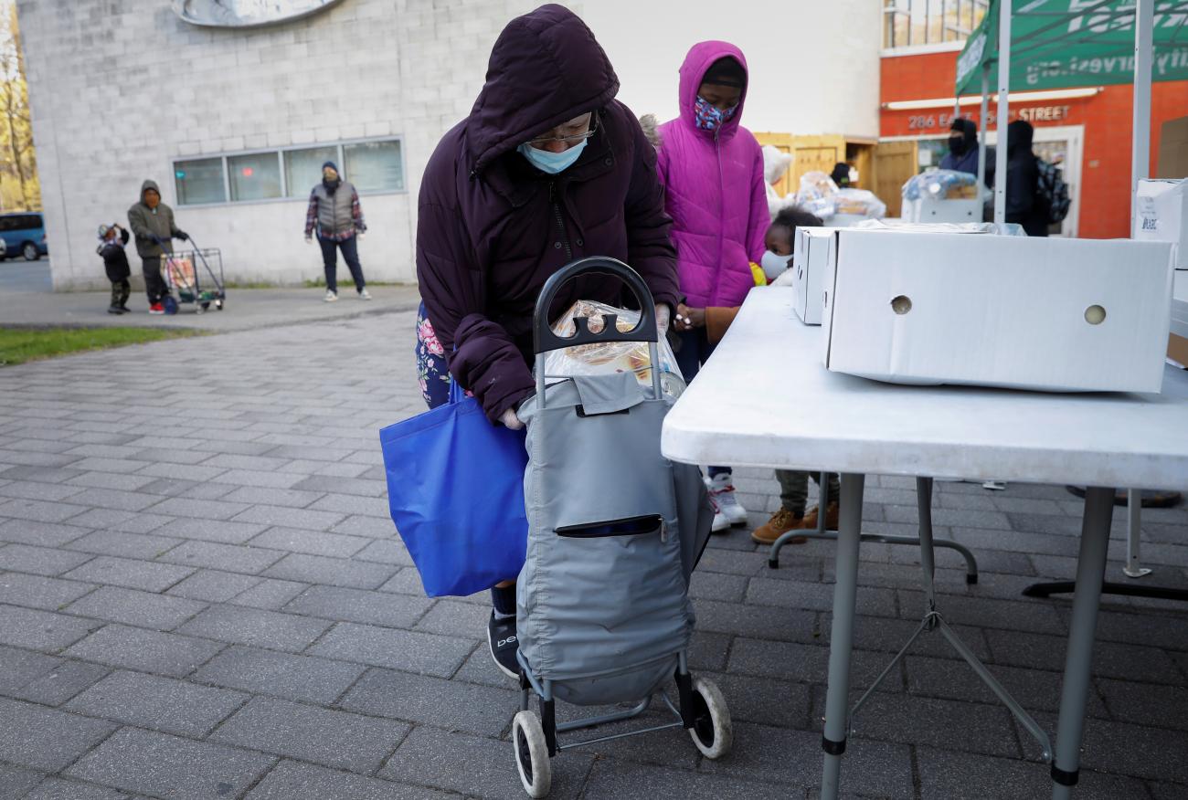 A family picks up packages of free food during a food-rescue operation run by City Harvest during the outbreak of the coronavirus disease in New York City on April 22, 2020.