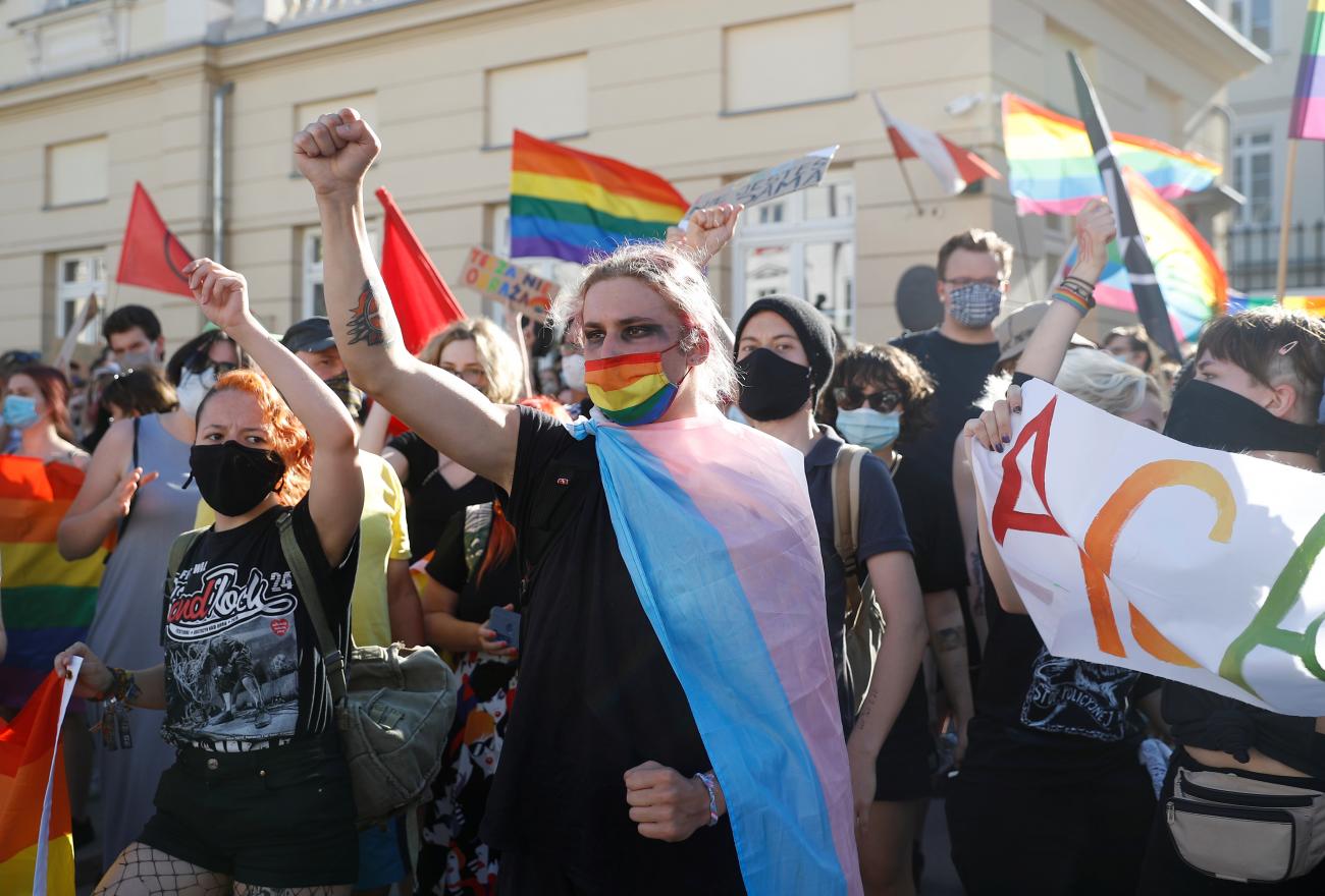 Pro-LGBT demonstrators gesture as Polish nationalists gather to protest against what they call "LGBT aggression" on Polish society, in Warsaw, Poland on August 16, 2020. 