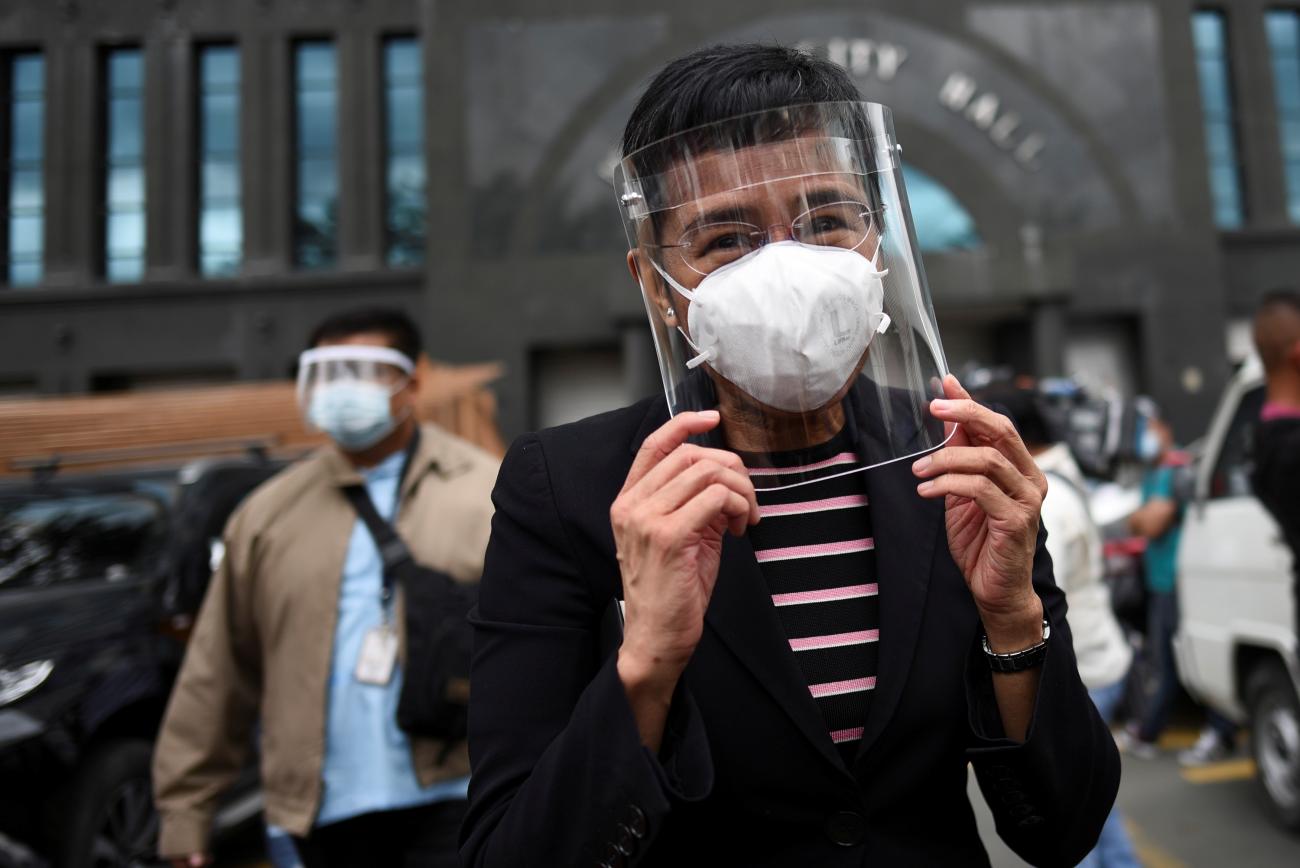 Rappler CEO Maria Ressa walks outside a regional trial court after the arraignment in her second cyber libel case, in Makati City, Metro Manila, Philippines on December 15, 2020.