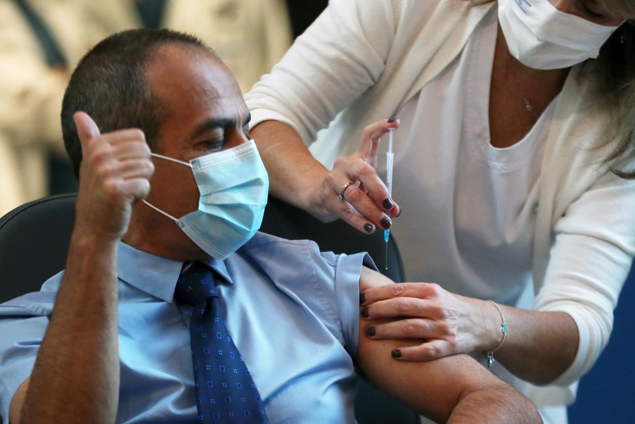 Dr. Ronni Gamzu, head of Ichilov hospital and former Israeli coronavirus chief is vaccinated against the coronavirus disease (COVID-19) as Israel kicks off a coronavirus vaccination drive, at Tel Aviv Sourasky Medical Center (Ichilov Hospital) in Tel Aviv, Israel on December 20, 2020.