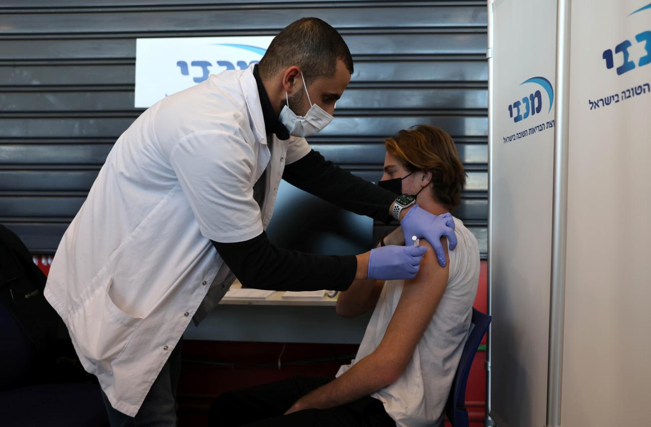 A teenager receives a vaccination against the coronavirus disease, in Tel Aviv, Israel on January 24, 2021.