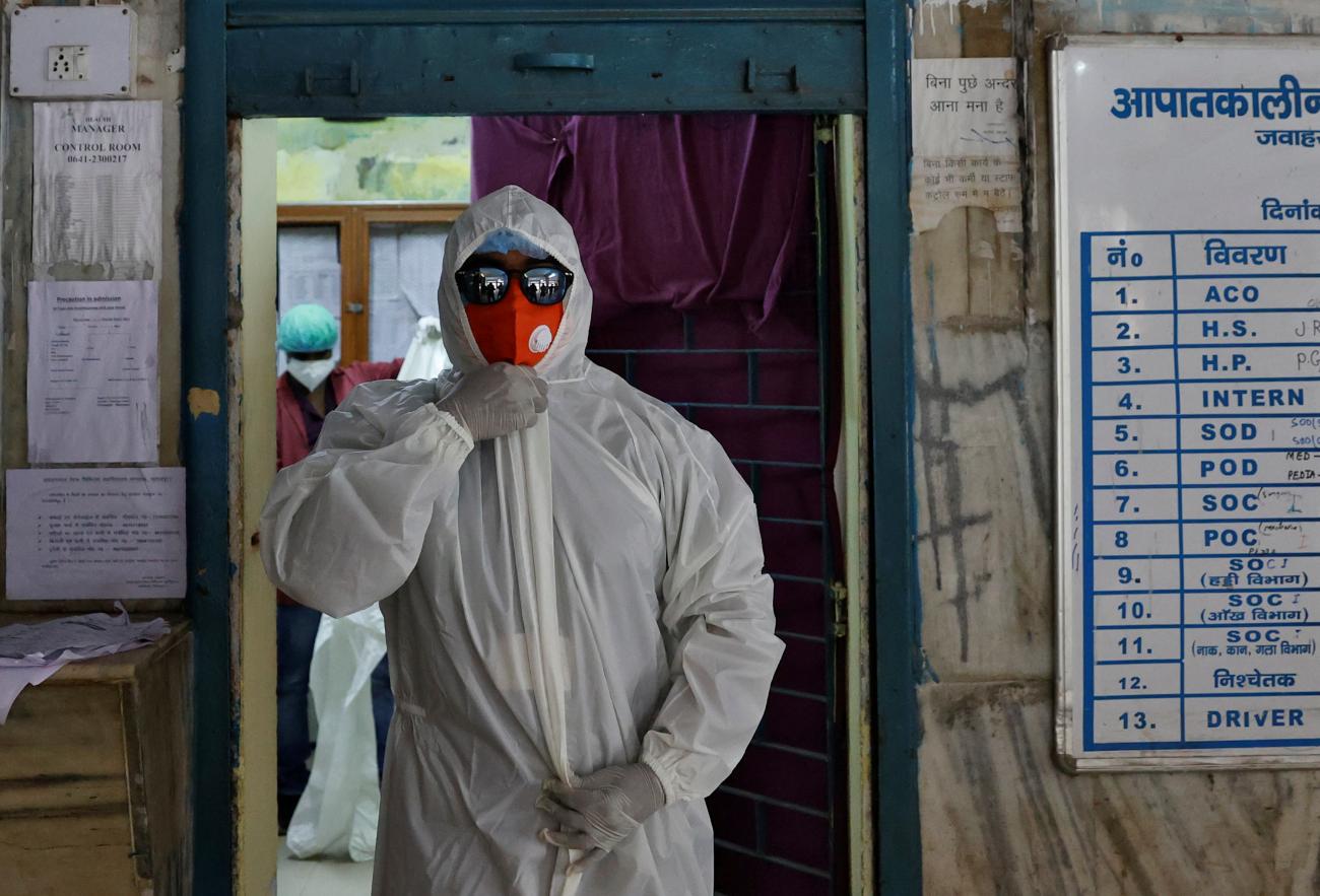 A medical worker, wears a pair of sunglasses as part of his PPE as he gets ready to transfer a COVID-19 patient from the emergency ward to the ICU in Bhagalpur, Bihar, India, on July 27, 2020.