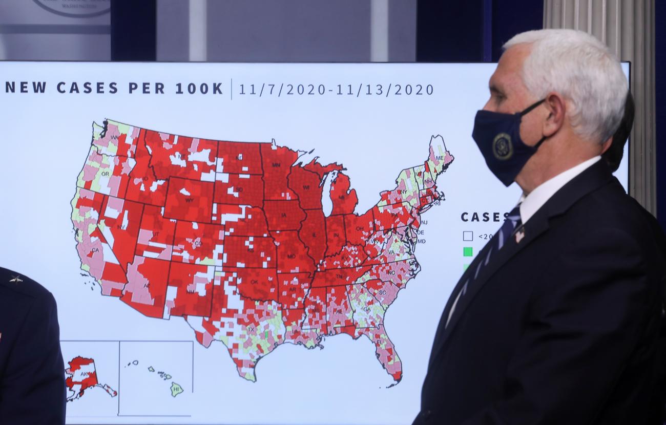 U.S. Vice President Mike Pence stands in front of a map of the United States indicating the spread of coronavirus disease (COVID-19) portrayed as new cases per 100,000 population as Pence leads a briefing by the White House coronavirus task force in the Brady press briefing room at the White House in Washington, U.S