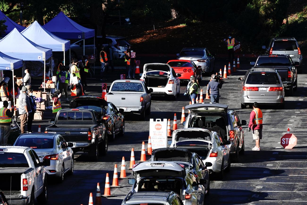 People wait in their vehicles at a drive-thru food distribution organized by the Los Angeles Regional Food Bank, as the U.S. Senate grapples with whether to increase payments to Americans reeling from the coronavirus disease (COVID-19) pandemic, in West Covina, California, U.S. December 29, 2020. 