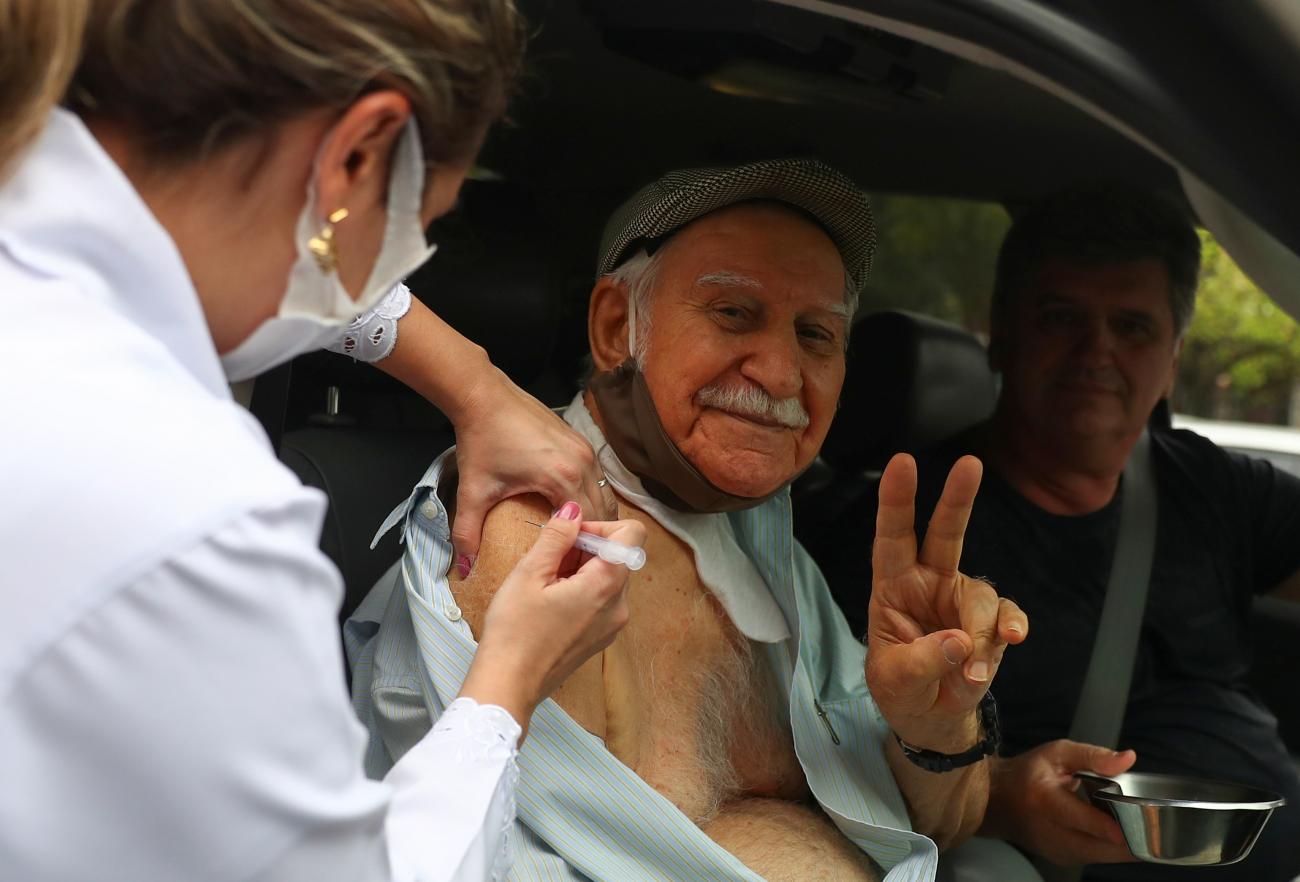An elderly resident receives Sinovac's coronavirus disease (COVID-19) vaccine at a drive-thru centre for seniors citizens in Rio de Janeiro, Brazil, February 5, 2021.
