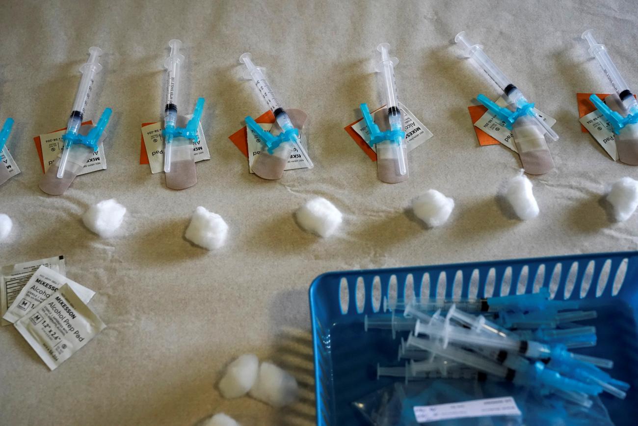 Numbers of syringes filled with the Moderna's vaccines against coronavirus disease (COVID-19) are seen on a table at a drive-through vaccination site in Robstown, Texas, U.S. February 9, 2021.