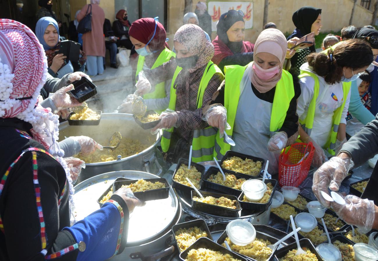 Volunteers prepare free meals to be distributed to people in need, as part of the weekly Tkiyet al-Salt initiative, in the city of Salt, Jordan on February 13, 2021.