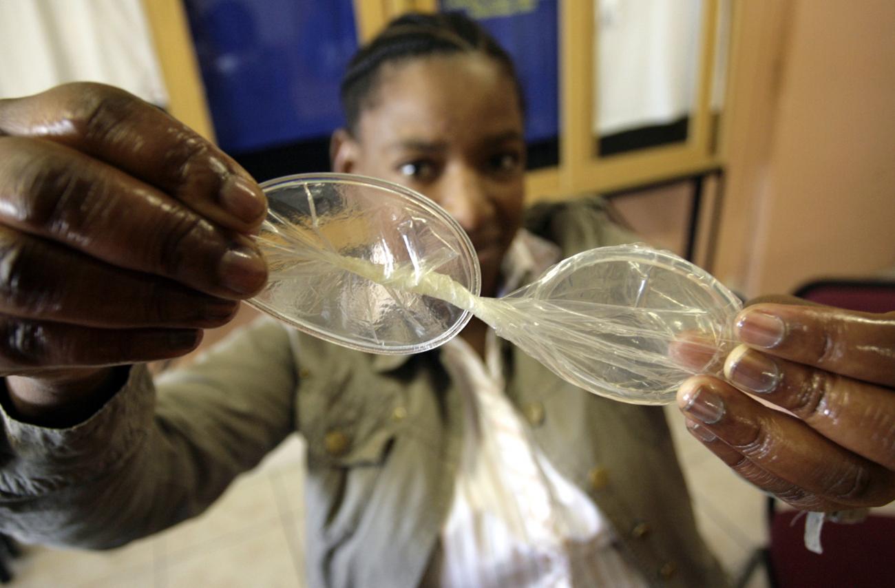 A human right's activist demonstrates using a female condom at the offices of the Treatment Action Campaign in Khayelitsha, near Cape Town, South Africa on March 19, 2009.