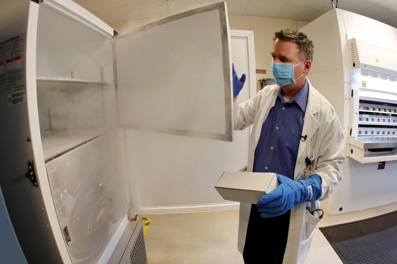 A pharmacy supervisor opens the door of a special freezer that holds the Pfizer vaccine at LAC USC Medical Center in Los Angeles, California on December 10, 2020.