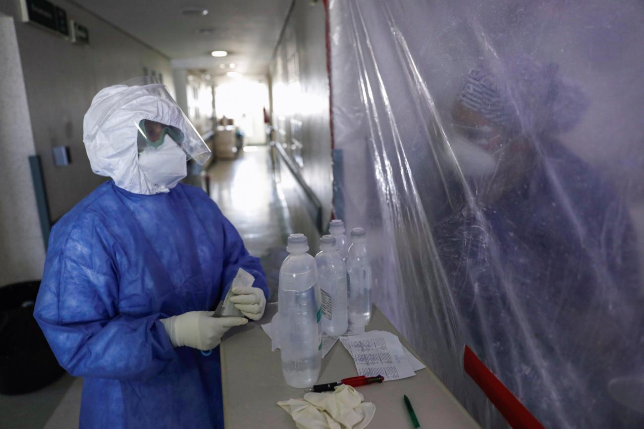 Nurses chat through a plastic sheet at the maternity ward for mothers infected with coronavirus disease, at the Maternal Perinatal Hospital 'Monica Pretelini Saenz', in Toluca, Mexico on February 4, 2021.