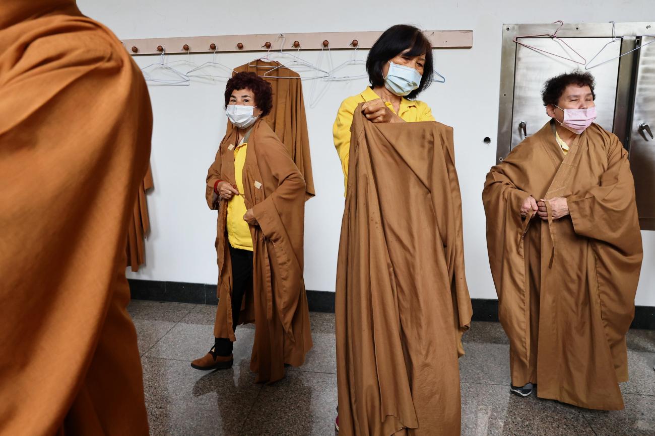 Women wear protective masks to prevent the spread of the coronavirus disease (COVID-19) while preparing for prayer during the Lunar New Year holiday at a temple in Taipei, Taiwan on February 14, 2021.