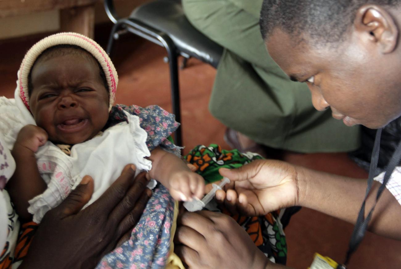A child is given an injection as part of a malaria vaccine trial at a clinic in the Kenya coastal town of Kilifi, November 23, 2010