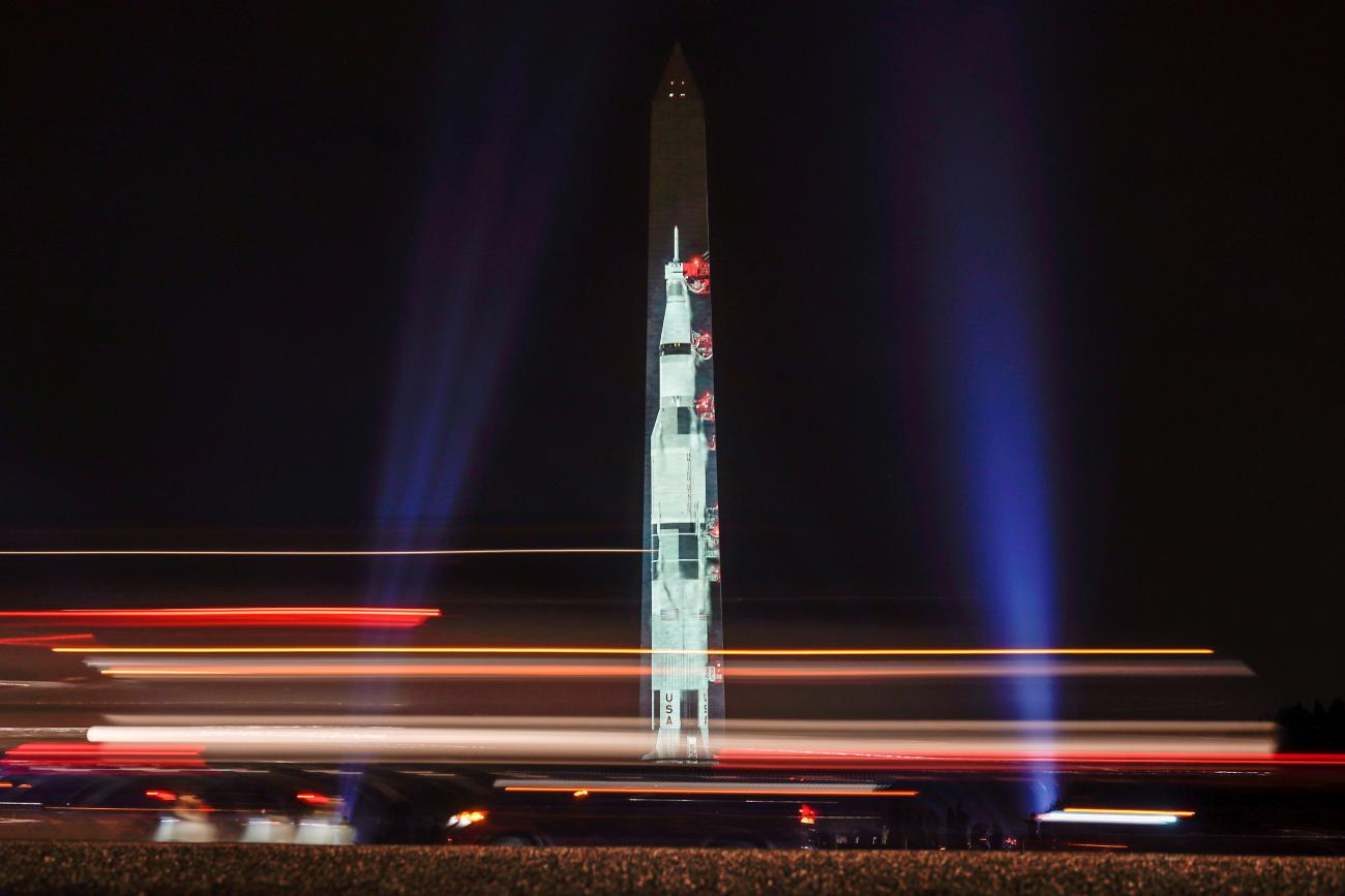 Traffic passes by an image of the Saturn V rocket, which launched the Apollo 11 astronauts into space, as it is projected onto the side of the Washington Monument to mark the 50th anniversary of the first lunar mission in Washington, U.S., July 16, 2019.