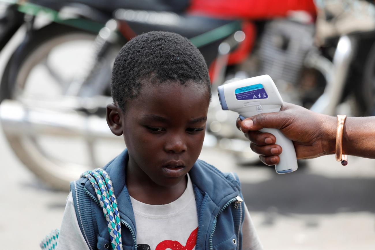 A health worker uses a thermometer to checks the temperature of a child in Goma, Democratic Republic of Congo on August 3, 2019.