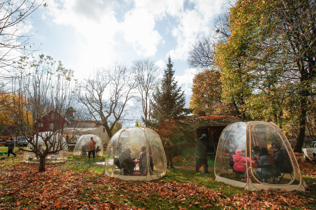 Community members gather by household in "bubbles" for a training session as part of an outreach program to the Black community to increase vaccine trial participation in New York on November 10, 2020