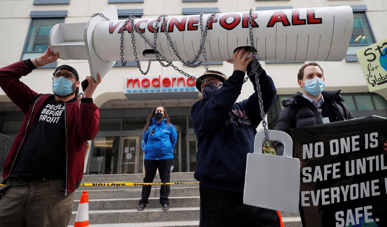 Demonstrators take part in a protest organized by the People's Vaccine Alliance demanding global distribution of COVID-19 vaccines in Cambridge, Massachusetts on March 11, 2021.