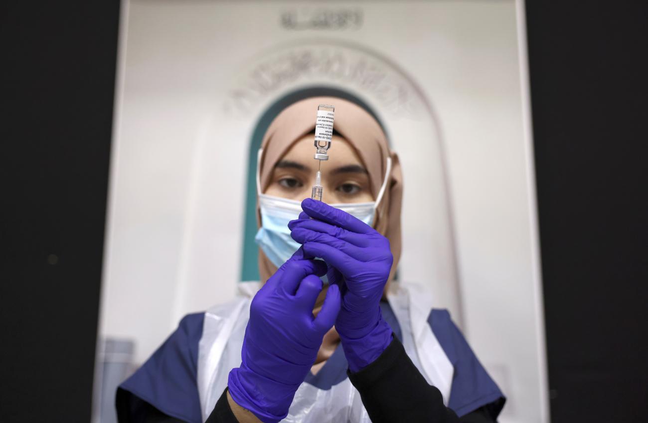 A medical worker prepares an injection with a dose of AstraZeneca coronavirus vaccine, at a vaccination centre in Baitul Futuh Mosque, amid the outbreak of coronavirus disease in London, Britain on March 28, 2021.