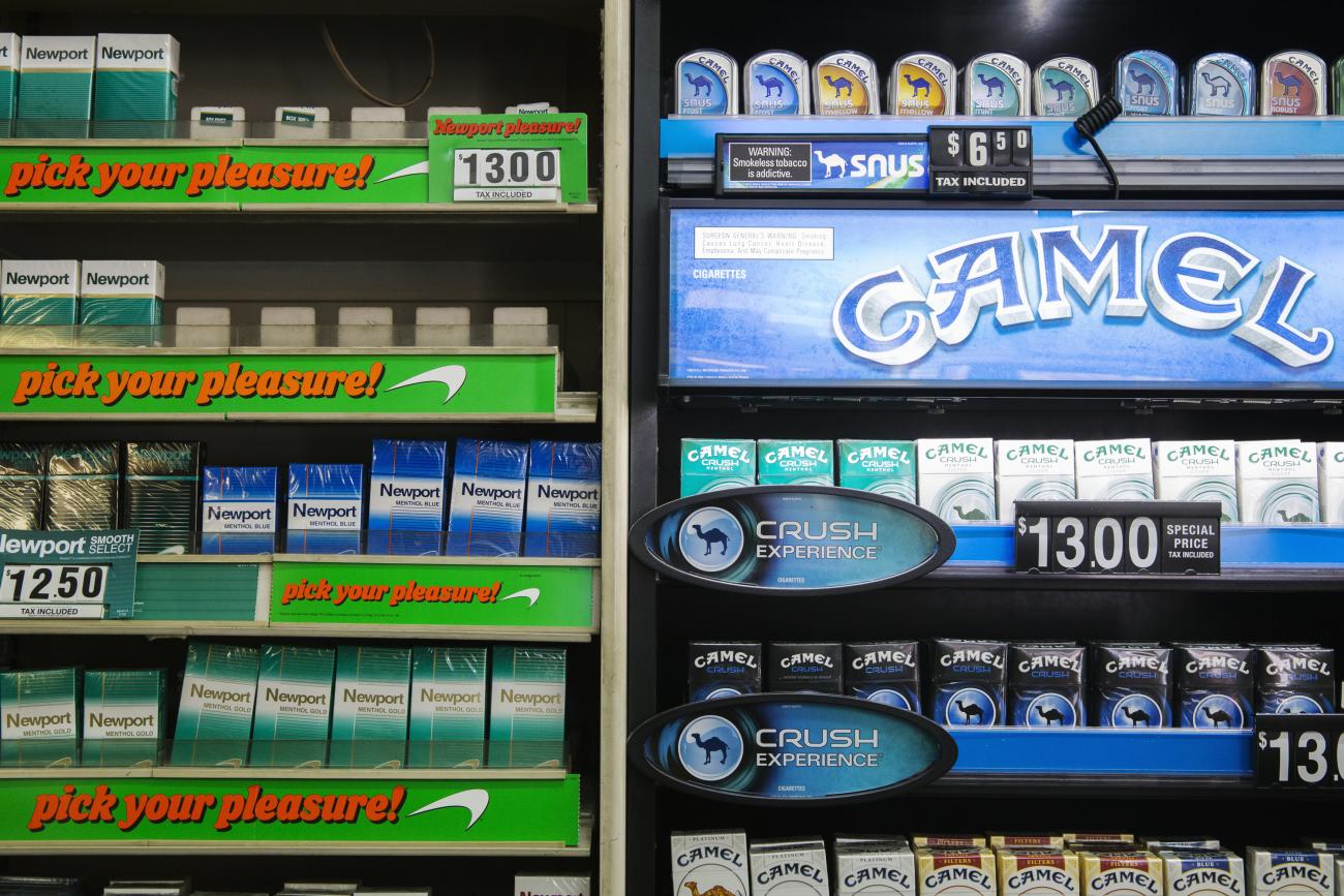 Newport and Camel cigarettes are stacked on a shelf inside a tobacco store in New York July 11, 2014