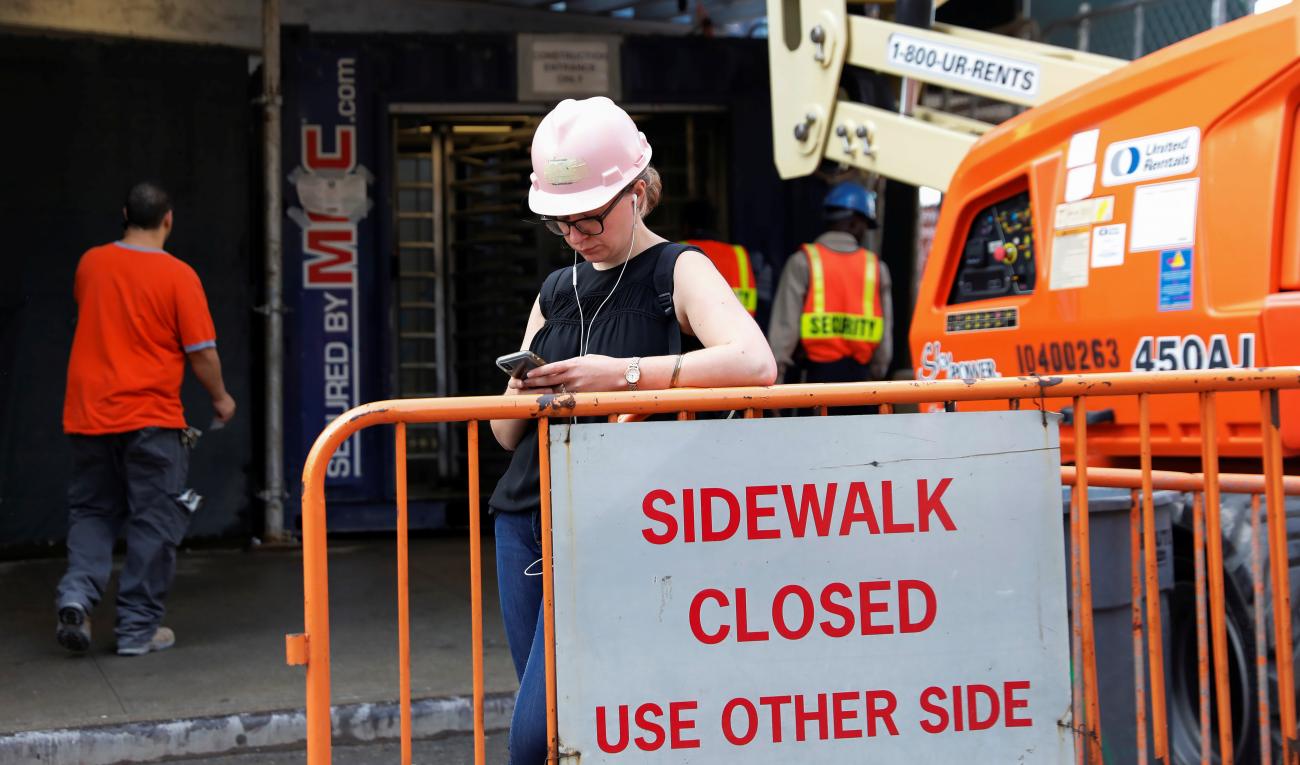 A female construction worker stands outside a construction site in Manhattan, New York on October 3, 2018. 