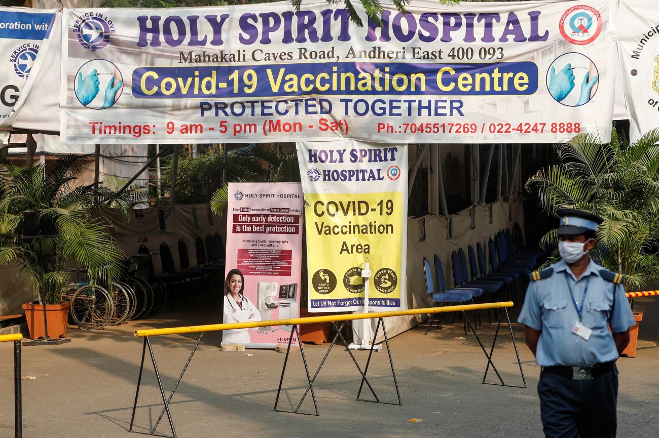 A private security guard stands outside an empty coronavirus disease (COVID-19) vaccination centre after Brihanmumbai Municipal Corporation (BMC) issued a notice about no vaccinations for three days, in Mumbai, India, April 30, 2021.