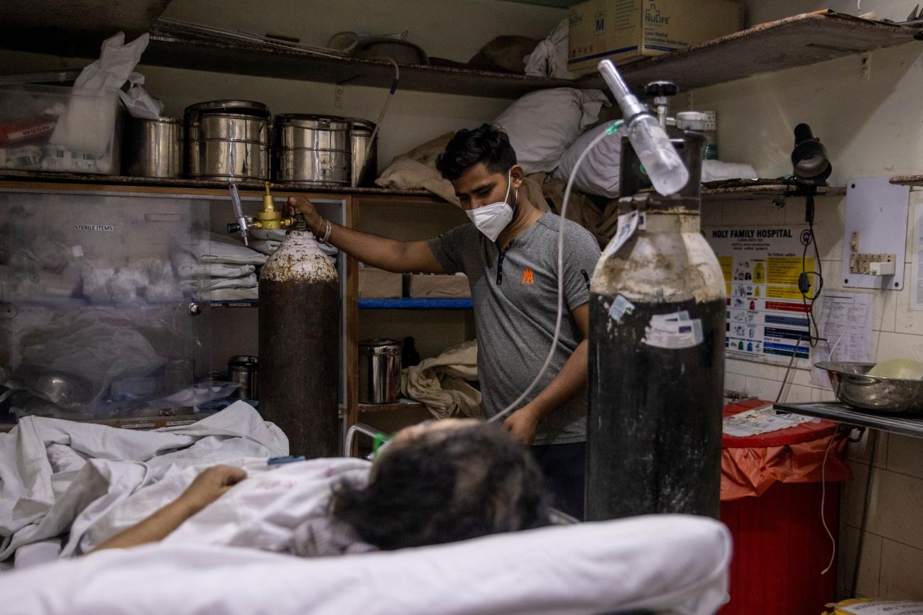 A woman suffering from the coronavirus disease (COVID-19) is treated inside an overcrowded casualty ward at a hospital in New Delhi, India, May 1, 2021.