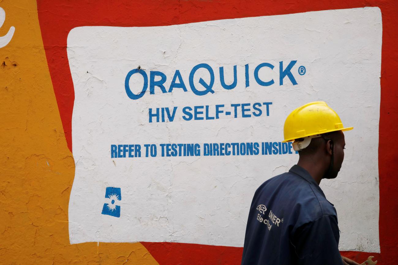 A man walks past an advertisement for the OraQuick HIV self-testing kit, manufactured by Orasure Technologies, in the Mathare area of Nairobi, Kenya on October 30, 2020. REUTERS/Baz Ratner