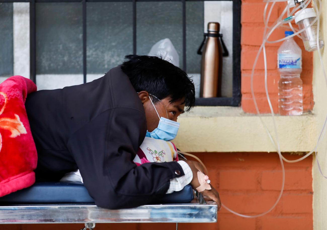 A patient receives oxygen as he waits outside of a hospital where beds are filled with COVID-19 patients during the second major coronavirus surge in Kathmandu, Nepal on May 10, 2021. REUTERS/Navesh Chitrakar