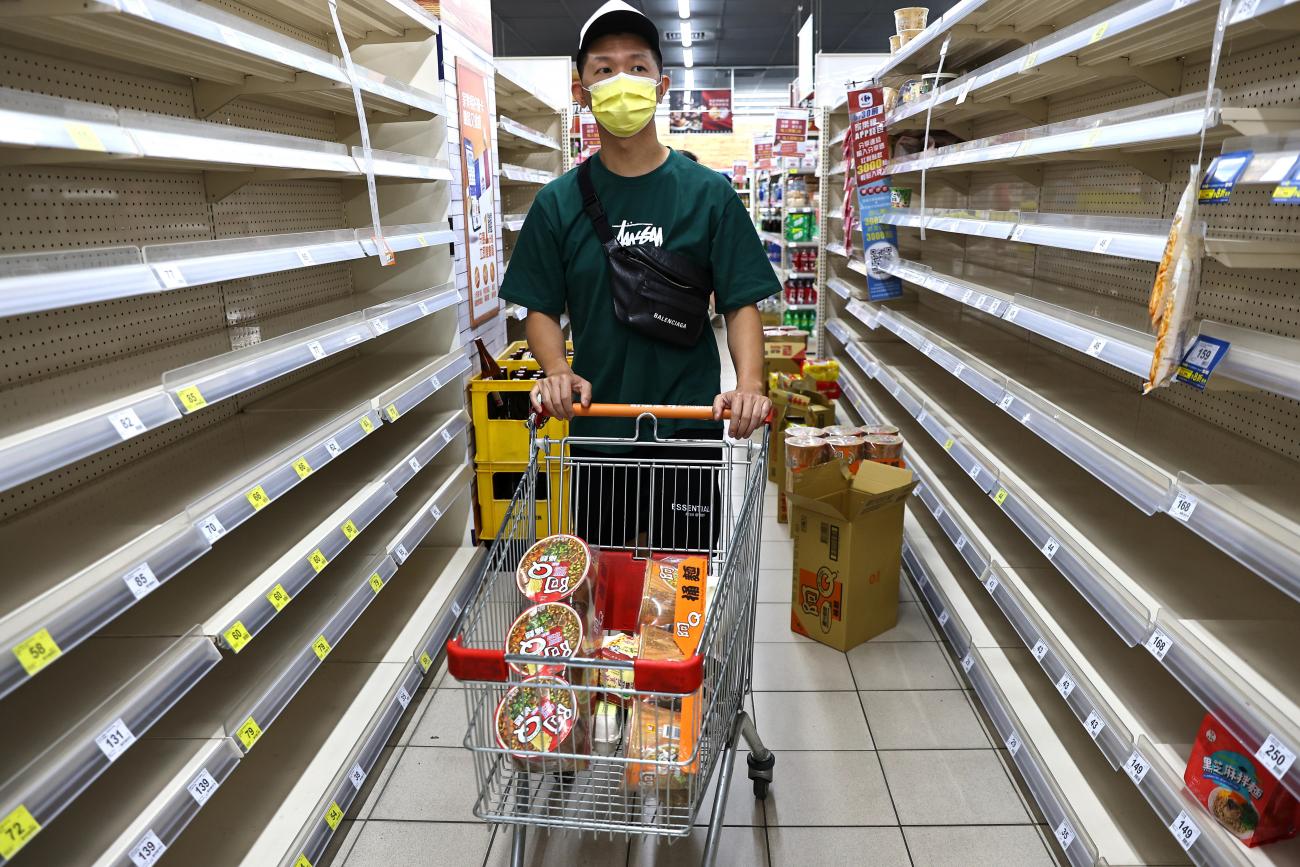 A shopper walks through empty shelves on May 18, 2021, following a surge of cases in Taipei, Taiwan.