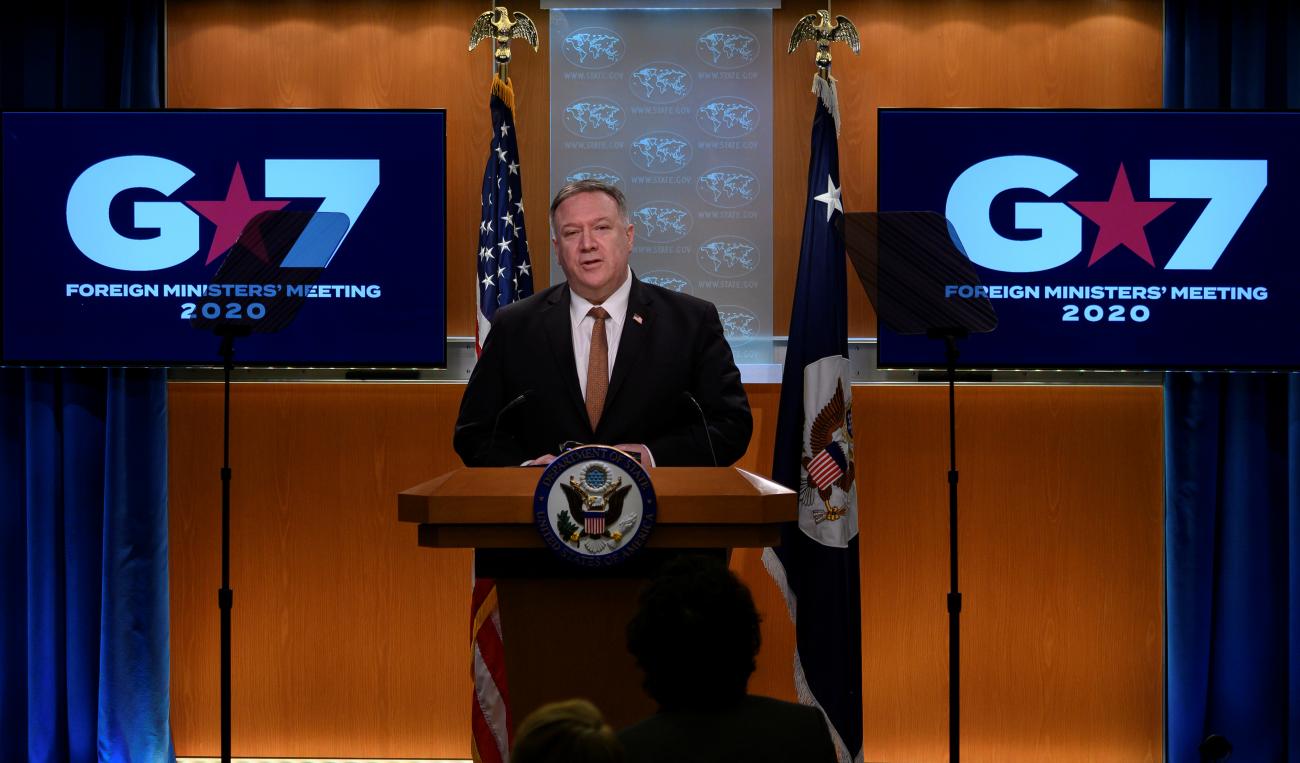 Screens project G7 images behind former U.S. Secretary of State Mike Pompeo as he speaks during a news conference at the State Department in Washington, DC on March 25, 2020