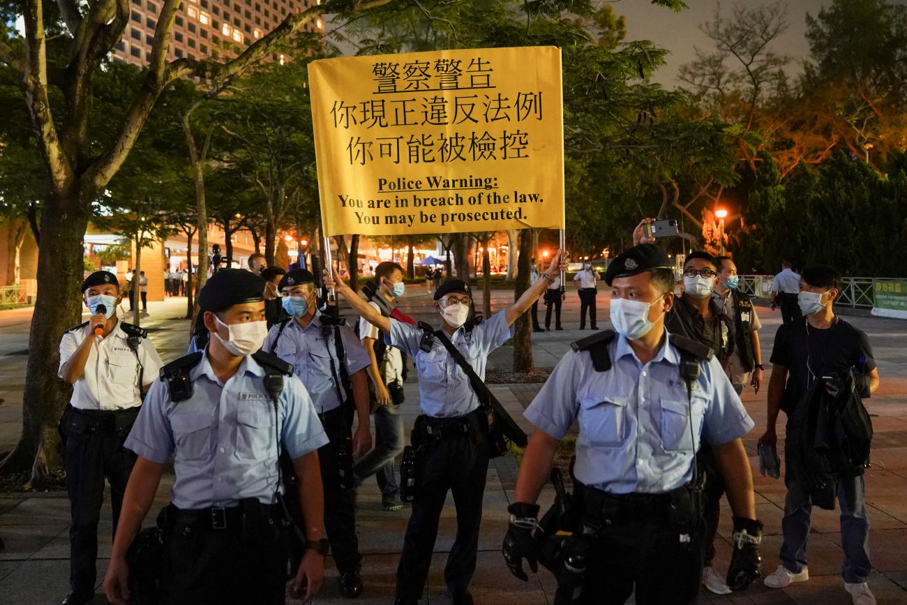 Police officers disperse mourners at Victoria Park, in Hong Kong, on the 32nd anniversary of the deadly protest in Beijing's Tiananmen Square in 1989. Photo taken in Hong Kong, China on June 4, 2021. 