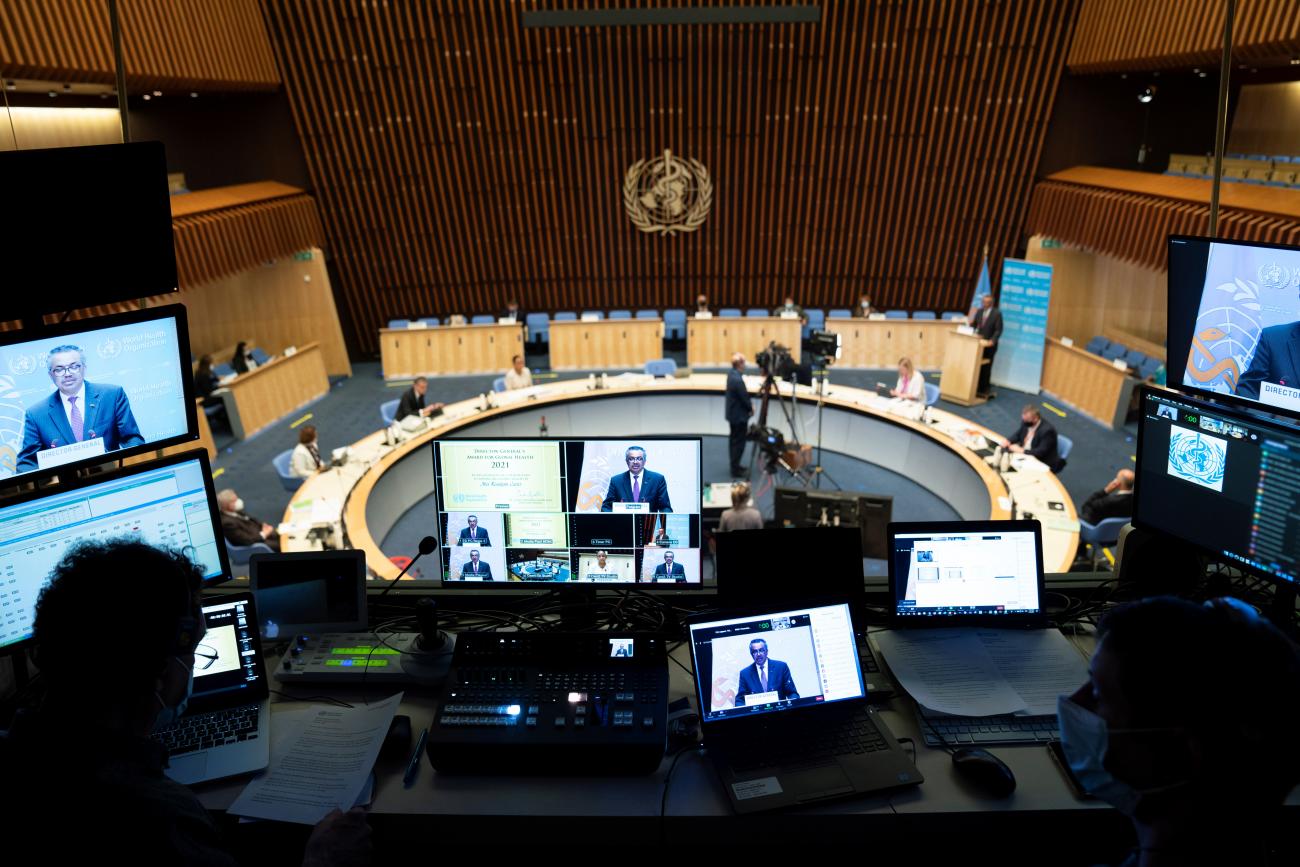WHO Director General Tedros Adhanom Ghebreyesus is seen on screens as he attends the World Health Assembly (WHA) amid the coronavirus disease pandemic in Geneva, Switzerland on May 24, 2021