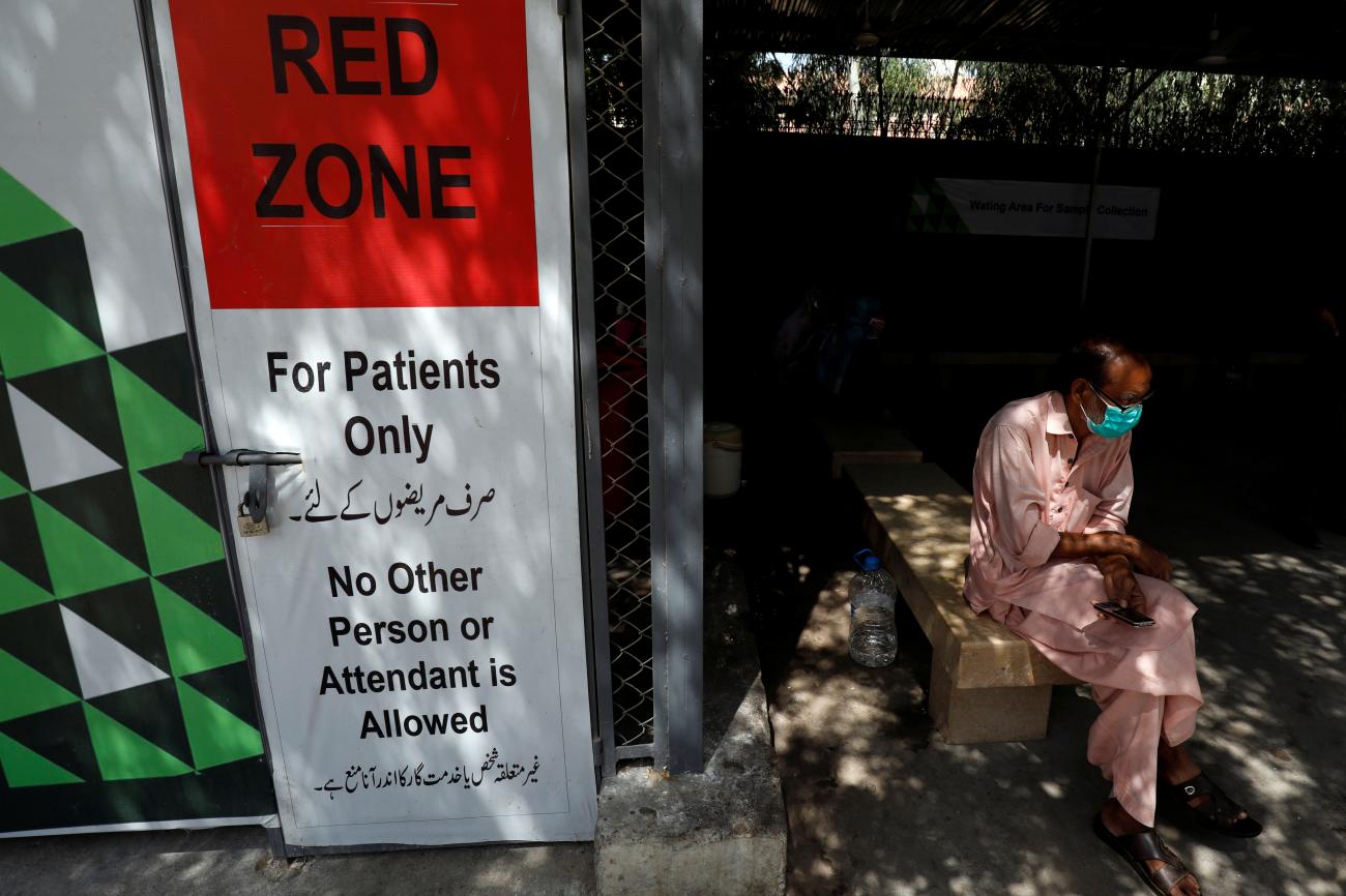 A man sits at the waiting area outside a sample collection facility for the coronavirus disease testing in Karachi, Pakistan on June 19, 2020.
