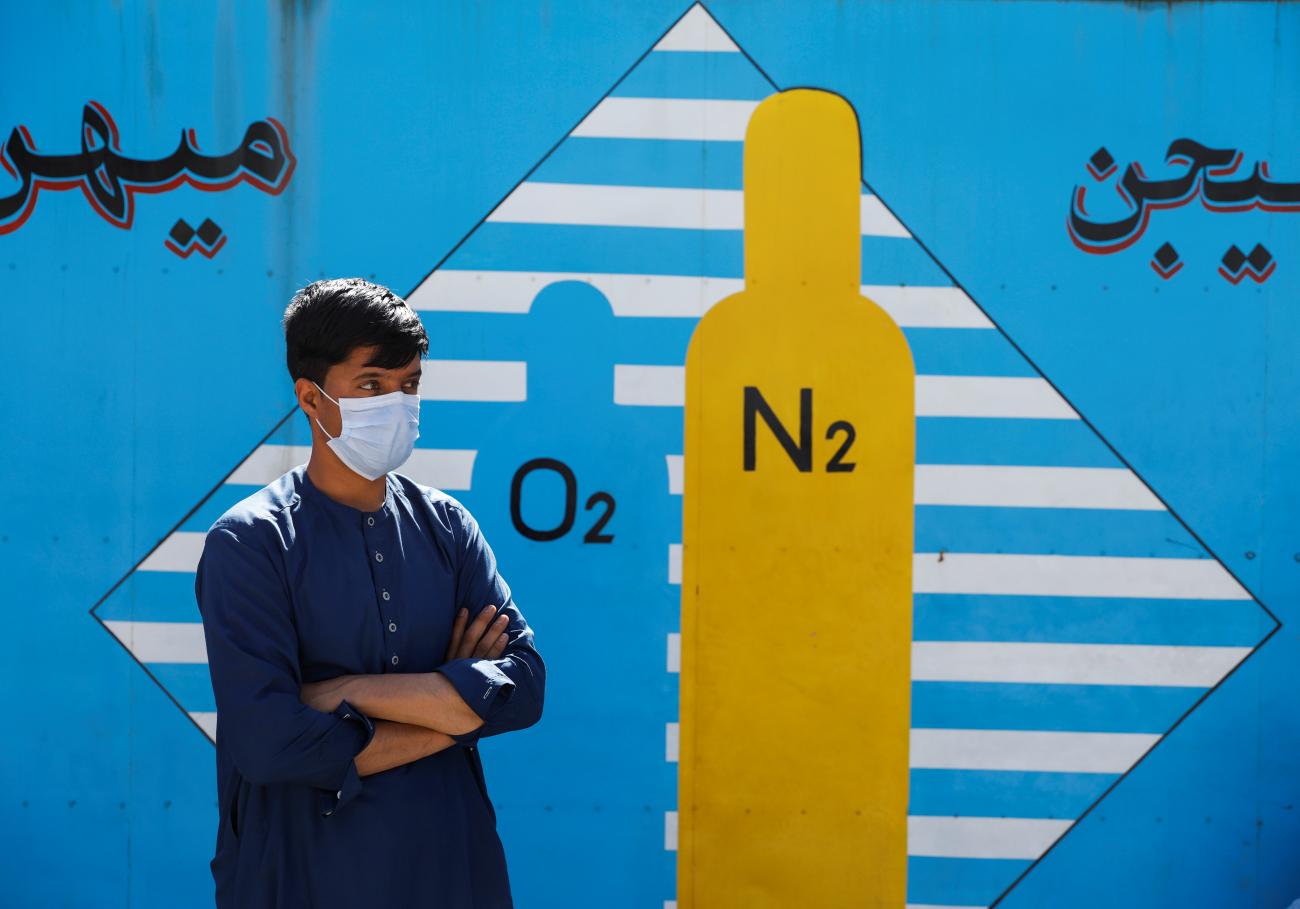 A man waits outside a factory to get his oxygen cylinder refilled, amidst the spread of the coronavirus disease (COVID-19) in Kabul, Afghanistan, on June 15, 2021. 