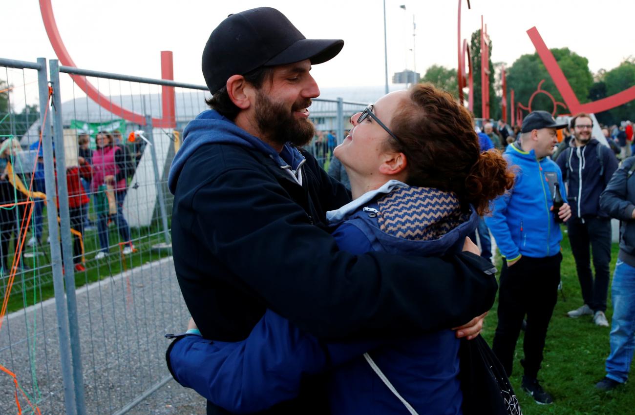 Couple Lukas from Switzerland and Leonie from Germany embrace after the removal of a double fence on the German-Swiss border, which was set up by Swiss and German authorities as a protection measure due to the spread of the coronavirus disease (COVID-19) in Kreuzlingen, Switzerland May 15, 2020.