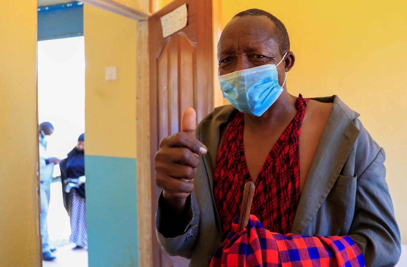 A man from the indigenous Maasai community gives a thumbs-up after receiving his second COVID-19 vaccine at the Bissil Health Centre, in Matapato North of Kajiado county, Kenya, on August 23, 2021.