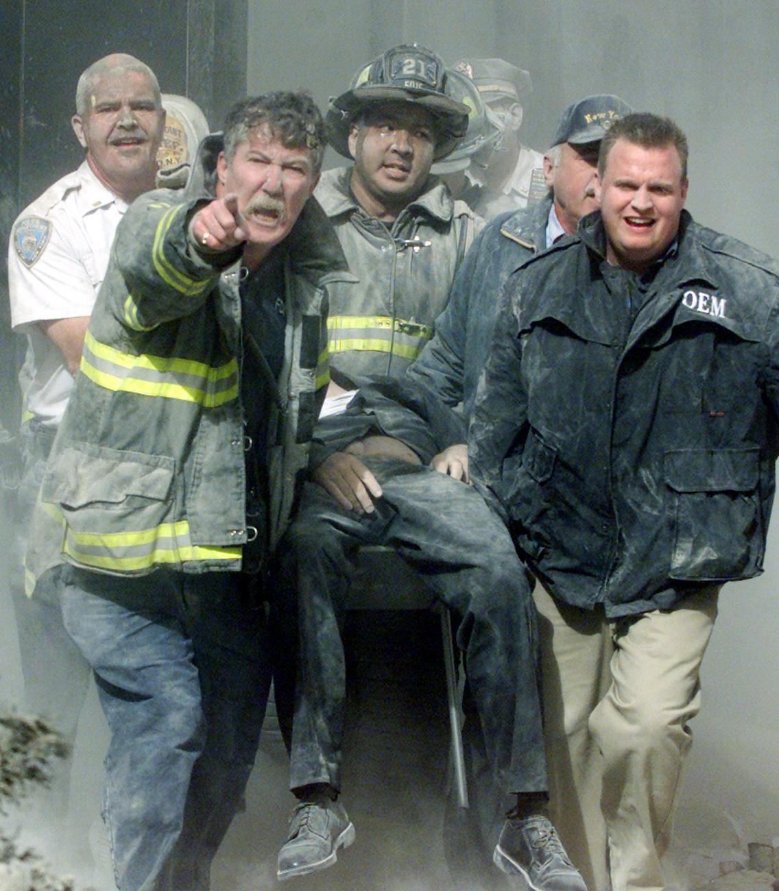 Rescue workers carry the body of FDNY Chaplain Mychal Judge after he was killed in the collapse of the South Tower at the World Trade Center in New York September 11, 2001