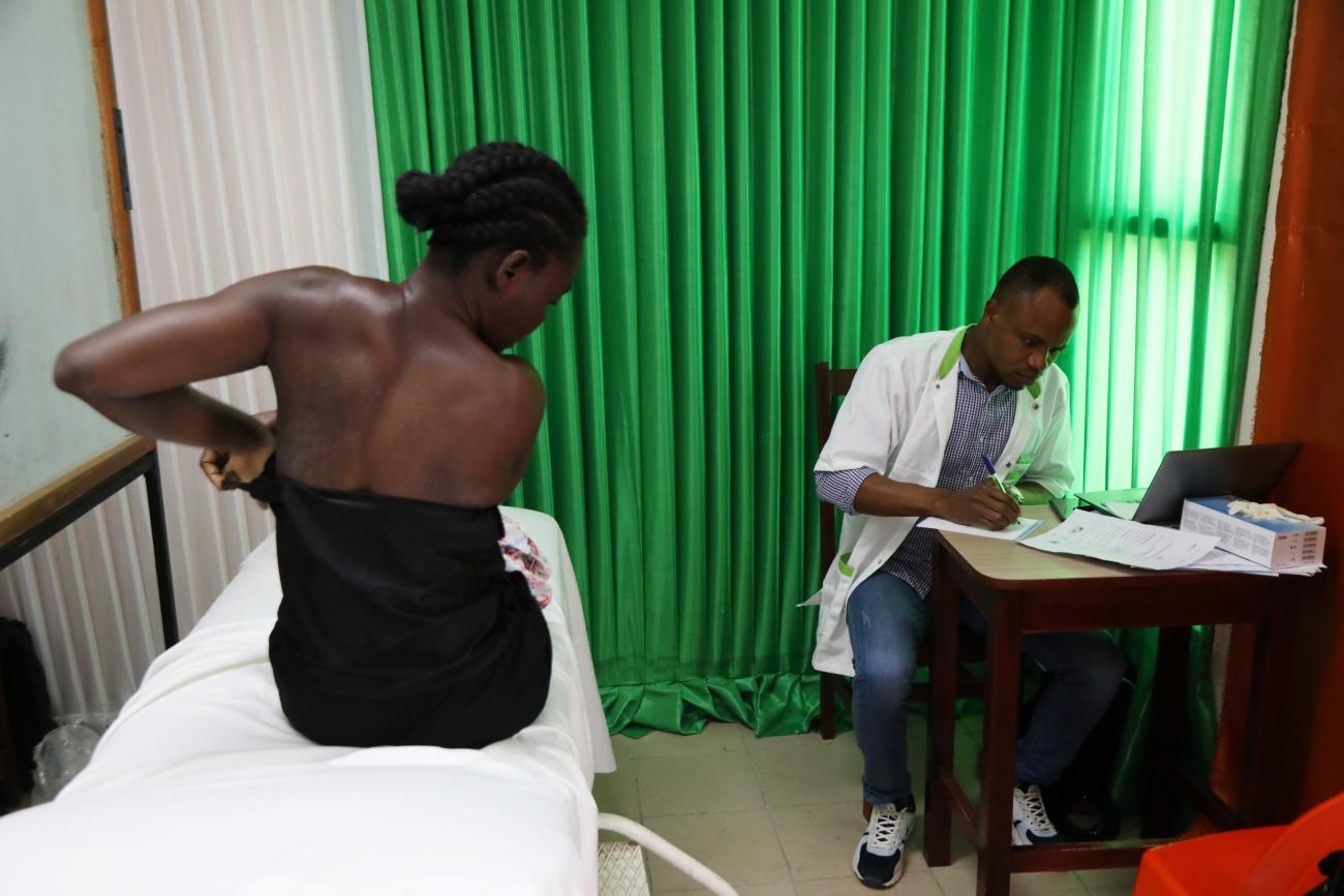 A woman prepares for a screening during the breast cancer prevention campaign in Abidjan, Ivory Coast, on October 12, 2019.