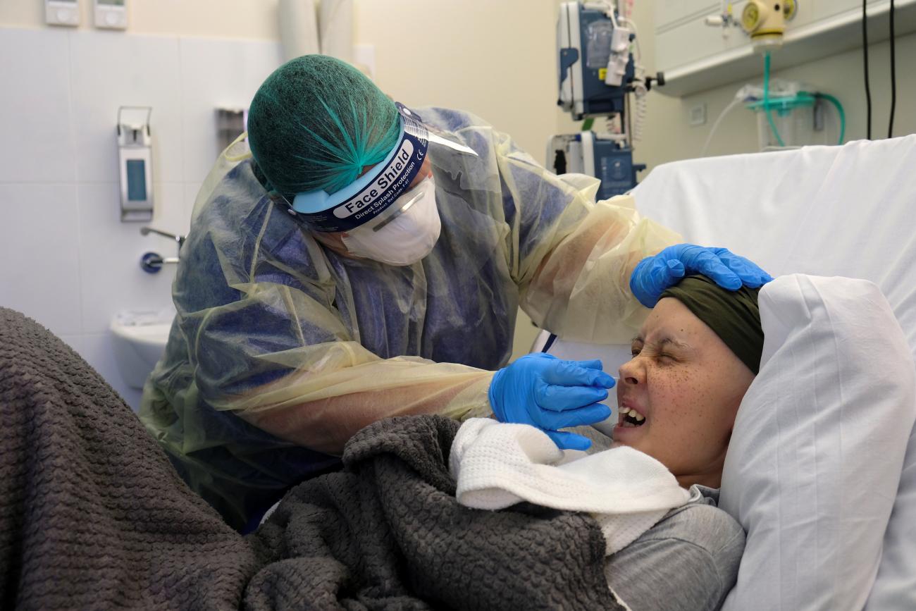 Doctor Silvana Zammit takes a swab sample from Rebecca Zammit Lupi, a 14-year-old cancer patient, after Rebecca displayed some symptoms of COVID-19, in her room at Rainbow Ward in Sir Anthony Mamo Oncology Centre at Mater Dei Hospital, during the Coronavirus disease (COVID-19) outbreak, in Tal-Qroqq, Malta, May 5, 2020.