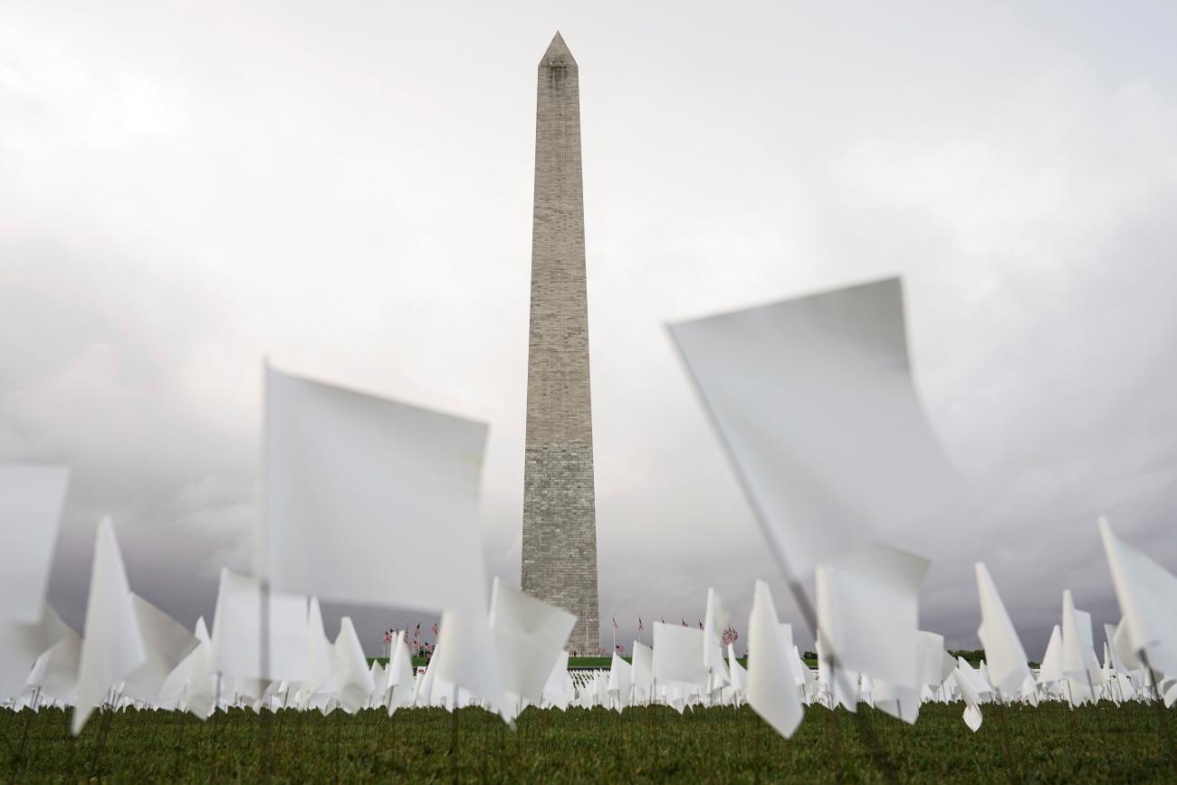 White flags, which represent Americans who have died of coronavirus disease, are placed across 20 acres of the National Mall in front of the Washington Monument, in Washington, DC, on September 17, 2021. 