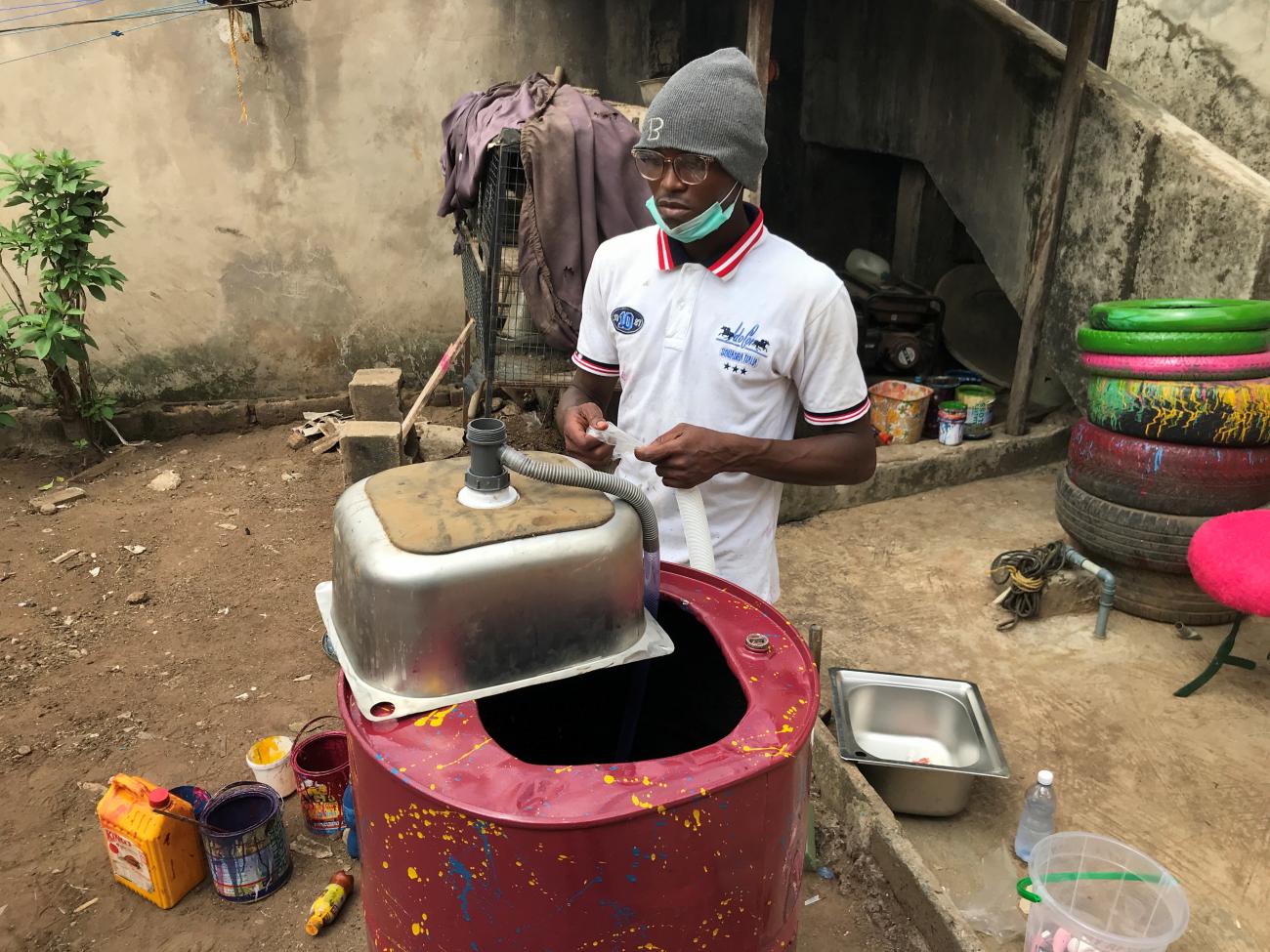 Bamigbose Adams, an artist using upcycled materials, makes a mobile hand-washing unit from a metal drum in his workshop in Igando, Lagos, Nigeria March 28, 2020