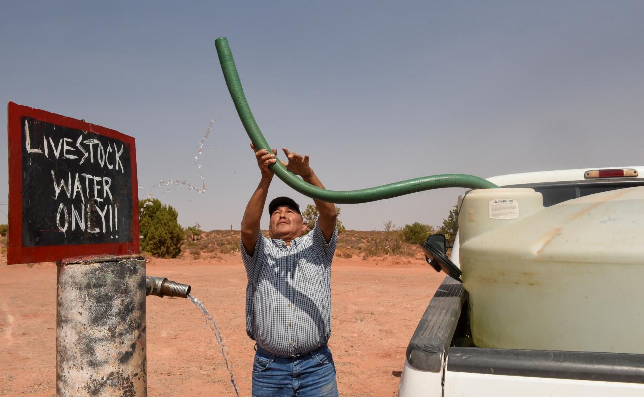 A member of the Navajo Nation fills up his water tank at a livestock water spigot in the Bodaway-Gap Chapter on the Navajo Nation, in Gap, Arizona, on September 17, 2020.